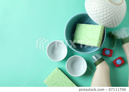 Concept of Dishwashing detergent accessories on mint background Concept of Dishwashing detergent accessories on mint background 87111706