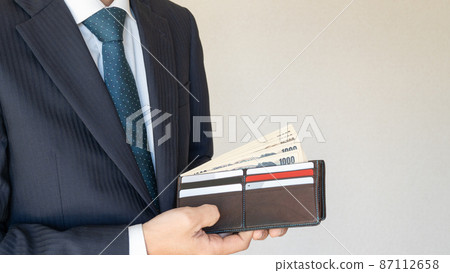 Men in suits | Wallet and wad / payday image Men in suits | Wallet and wad / payday image 87112658