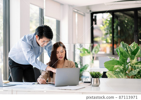 Entrepreneur Asian businessman and woman discussing new business project in laptop computer in modern meeting room. Entrepreneur Asian businessman and woman discussing new business project in laptop computer in modern meeting room. 87113971