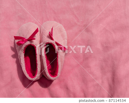 Plush baby's bootees pink velvet fabric texture top view. Smooth soft fluffy velvety satin cloth girly shiny rose female Plush baby's bootees pink velvet fabric texture top view. Smooth soft fluffy velvety satin cloth girly shiny rose female 87114534