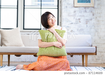 A young woman relaxing in the living room A young woman relaxing in the living room 87114689