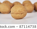 Walnuts on a white background one nut in the foreground 87114738