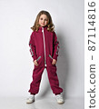 Happy stylish girl in a sports burgundy suit. a 87114816