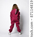 Happy stylish girl in a sports burgundy suit. a 87114819