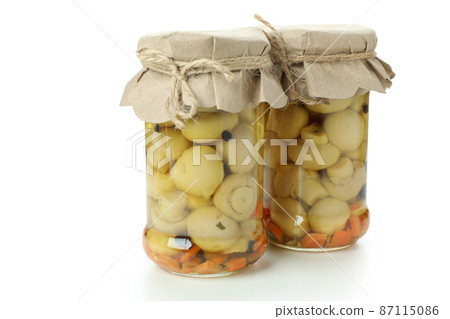Jars of marinated mushrooms isolated on white background Jars of marinated mushrooms isolated on white background 87115086