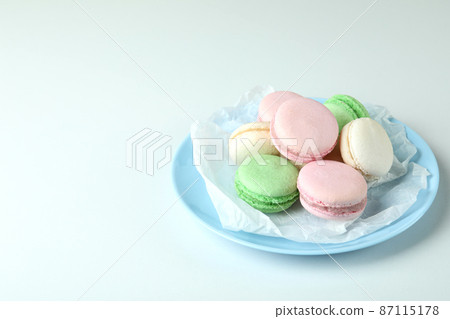 Concept of tasty dessert with macaroons on white background 87115178