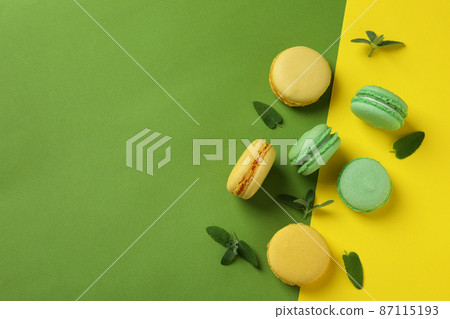 Concept of tasty dessert with macarons on two tone background 87115193