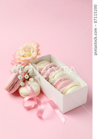 Concept of tasty dessert with macaroons on pink background Concept of tasty dessert with macaroons on pink background 87115200