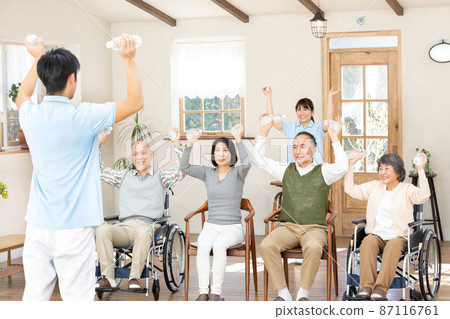 Seniors and healthcare professionals doing gymnastics in nursing homes Seniors and healthcare professionals doing gymnastics in nursing homes 87116761
