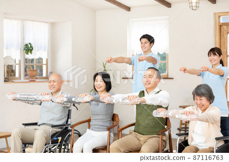 Seniors and healthcare professionals doing gymnastics in nursing homes Seniors and healthcare professionals doing gymnastics in nursing homes 87116763