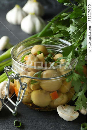 Concept of tasty food with marinated mushrooms on dark wooden table 87117660