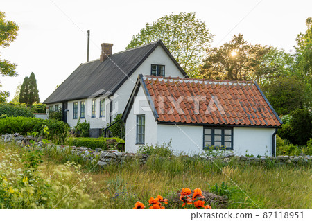 Image of beautiful garden with apple trees, flowers and scandinavian style summer house Image of beautiful garden with apple trees, flowers and scandinavian style summer house 87118951