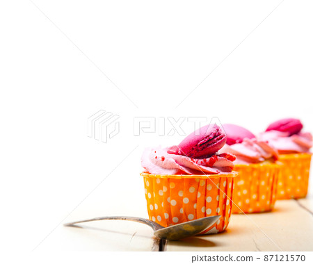 pink berry cream cupcake with macaroon on top 87121570