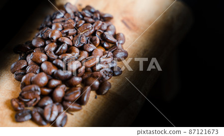 Cute wooden woodwork and coffee beans on a black background 87121673