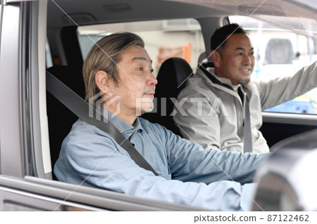 Middle-aged and older men driving with friends 87122462