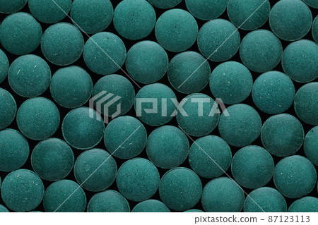 Spirulina tablets close up top view. Flat lay Healthy food supplement. Super food ingredient. top view 87123113