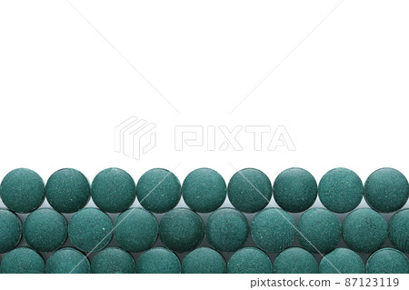 Spirulina tablets close up top view. Flat lay Healthy food supplement. Super food ingredient. top view place for text 87123119