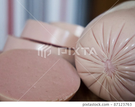 Boiled sausage cut into pieces, a close-up shot. 87123763