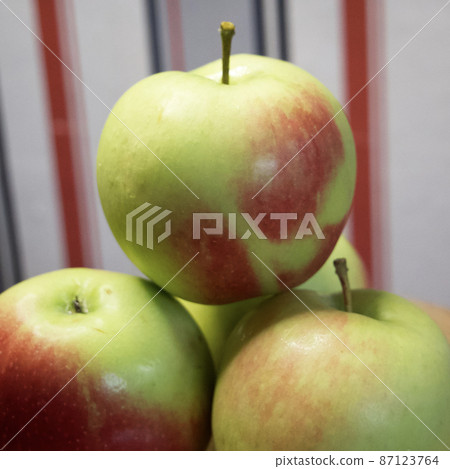 A bunch of juicy red-sided apples, a close-up shot. Ripe fruit. 87123764