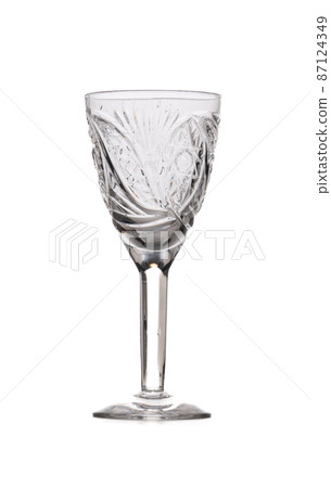 Inlaid glass for vodka on a high stem isolated on a white background. 87124349
