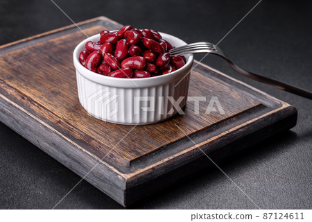 Canned red kidney beans in white bowl on a table Canned red kidney beans in white bowl on a table 87124611