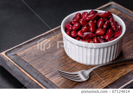 Canned red kidney beans in white bowl on a table 87124614