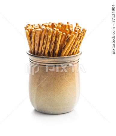 Salted sticks. Crispy pretzel sticks isolated on white background. 87124904