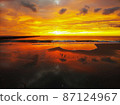 The dawn when the sea and the sky burn bright red 87124967
