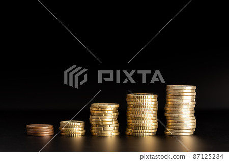 Rising Coin stacks on black background. Growth, income, savings concept. Copy space Rising Coin stacks on black background. Growth, income, savings concept. Copy space 87125284