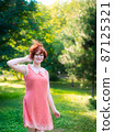 Laughing red haired girl on a sunny day having fun 87125321