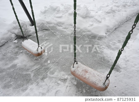 swing on the playground in the yard in winter 87125931
