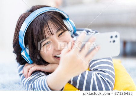 戴耳機聽音樂的年輕女子 戴耳機聽音樂的年輕女子 87126453