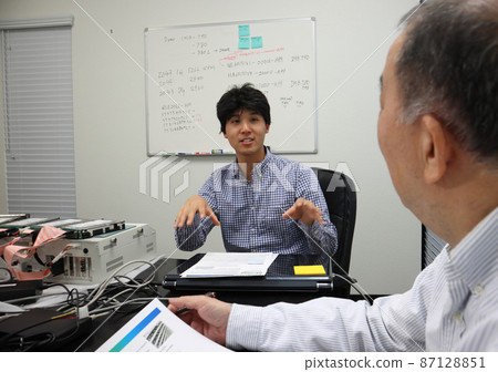 A businessman in a meeting with his boss at the company A businessman in a meeting with his boss at the company 87128851