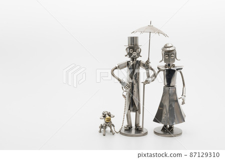 A model of a gentleman and a lady with a dog walking, a metal figure A model of a gentleman and a lady with a dog walking, a metal figure 87129310