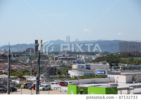 View of the cityscape including Akashi Kaikyo Bridge and Awaji Island from the south of Kobe Gakuen View of the cityscape including Akashi Kaikyo Bridge and Awaji Island from the south of Kobe Gakuen 87132733