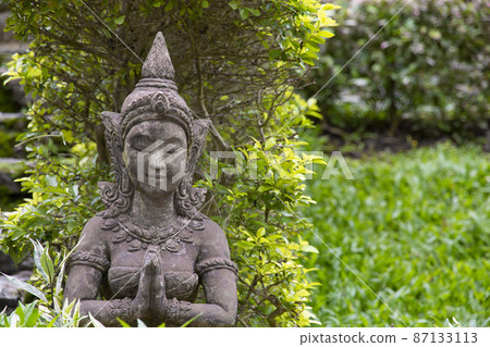 Old stone statue of a woman for garden decoration. Old stone statue of a woman for garden decoration. 87133113