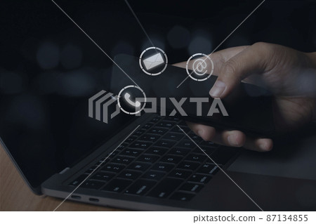 Young man using smartphone with icon phone, mail, and address. Customer support service contact us concept. 87134855