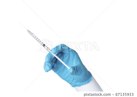 Hand wearing blue glove holding syringe. isolated on white background. 87135933