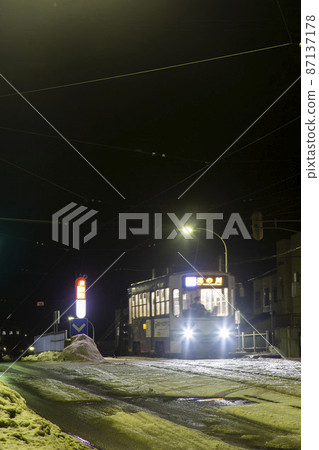 [Driver blurred] Hakodate tram stop at night, Aoyagicho tram stop 87137178