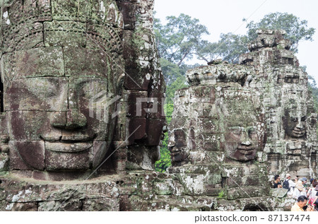 Giant human face statue of Angkor ruins Giant human face statue of Angkor ruins 87137474