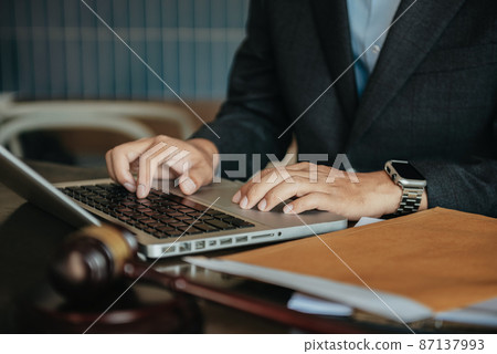 Male lawyer working at table at home office in the morning. Male lawyer working at table at home office in the morning. 87137993