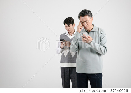 asian korean old and young two men using smartphone asian korean old and young two men using smartphone 87140006