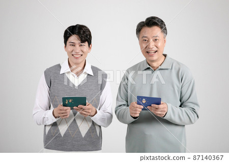 asian korean old and young two men holding a bankbook 87140367