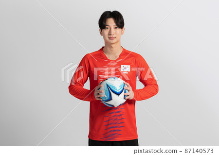 soccer football sports player, asian korean man with motions in studio background 87140573