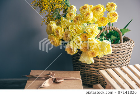 Basket with yellow flowers and gift box, copy space. Basket with yellow flowers and gift box, copy space. 87141826