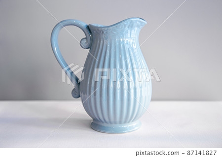 Beautiful textured blue jug for drinks close-up. Beautiful textured blue jug for drinks close-up. 87141827