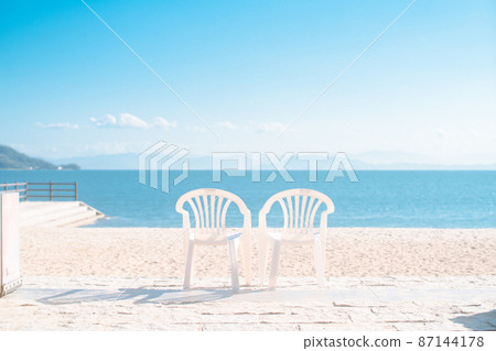 Blue sky and two white chairs Blue sky and two white chairs 87144178