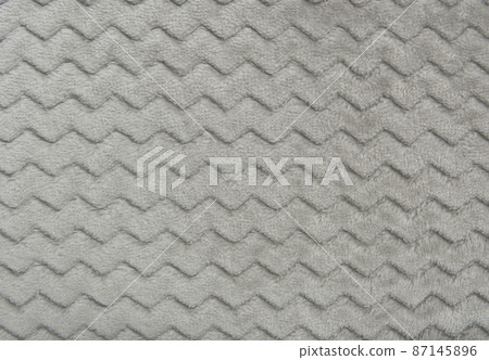 gray fleece blanket. fragment of drawing and fabric texture 87145896