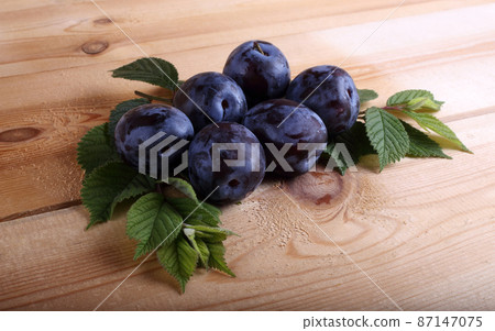 Plums on table 87147075