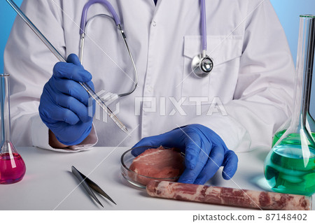 Doctor Tests Artificial Meat in Petri Dish with Glass Stick Doctor Tests Artificial Meat in Petri Dish with Glass Stick 87148402